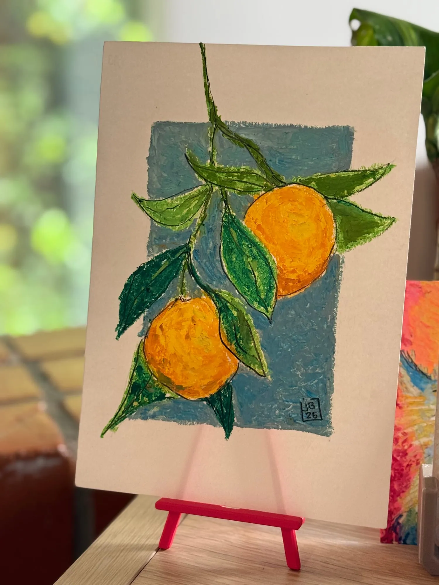 Naranjas en la rama — la pieza en el caballete del estudio